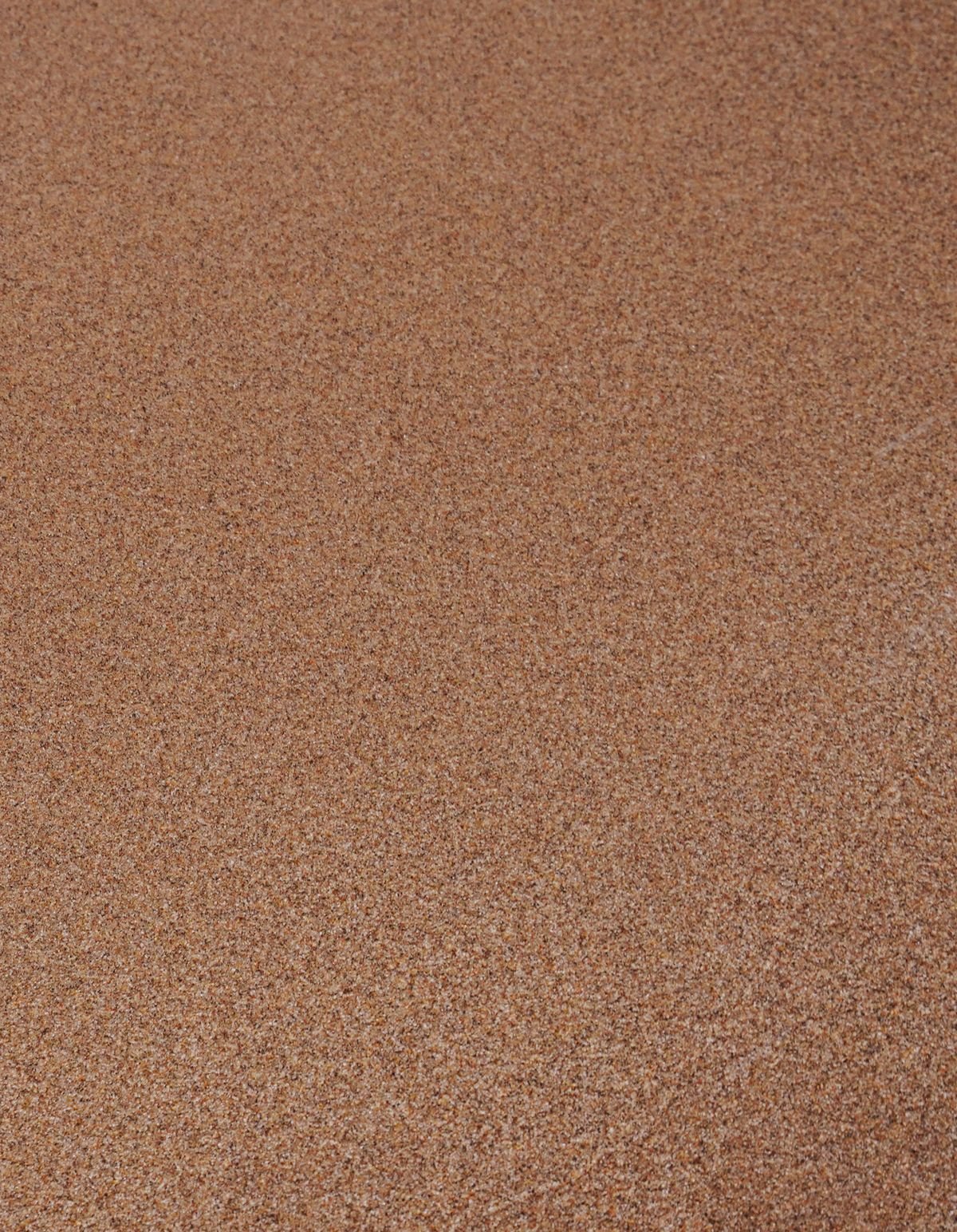 Close-up of coarse, granular brown substrate texture similar to porous volcanic aquarium soil