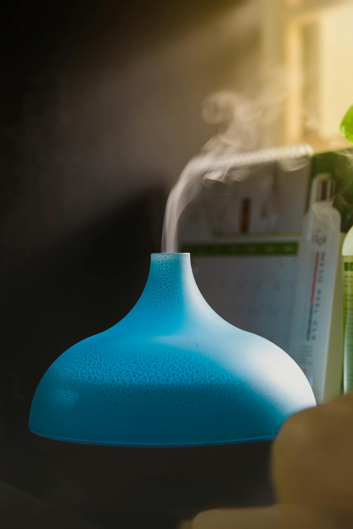 Blue humidifier releasing vapor