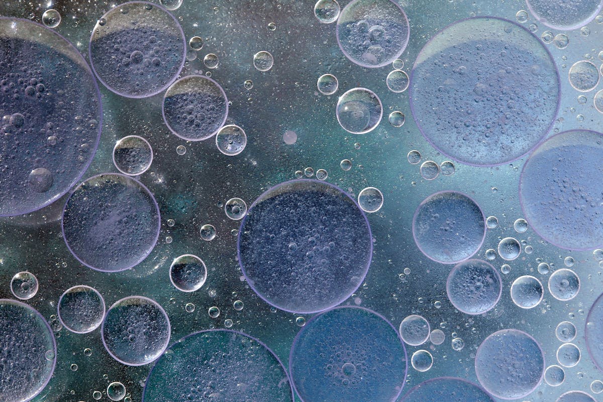 Close-up of oil and water bubbles creating abstract patterns representing oxidation