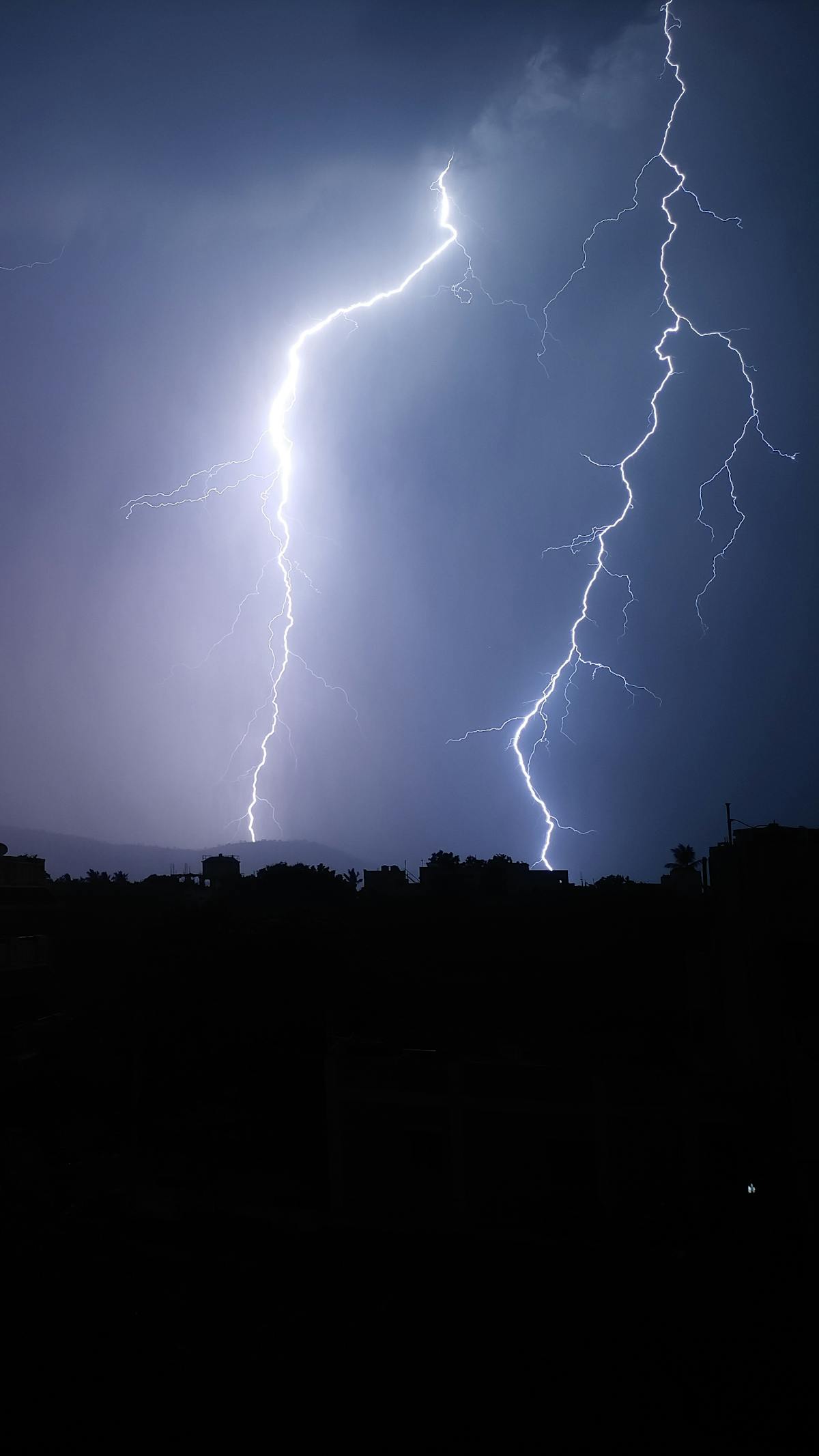 Intense lightning bolts illuminating the night sky during a powerful storm