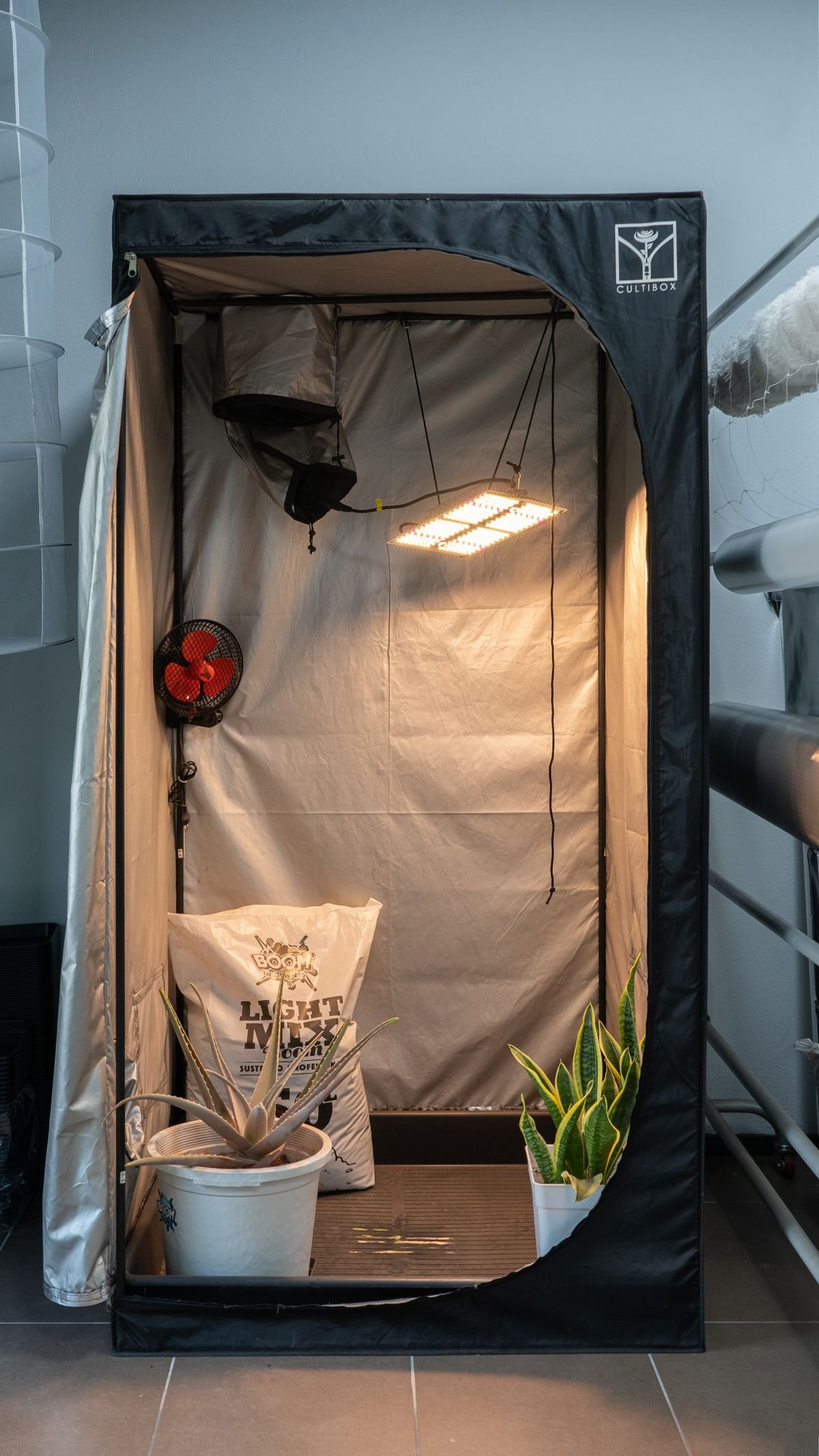 A grow tent with LED lights set up for indoor plant cultivation