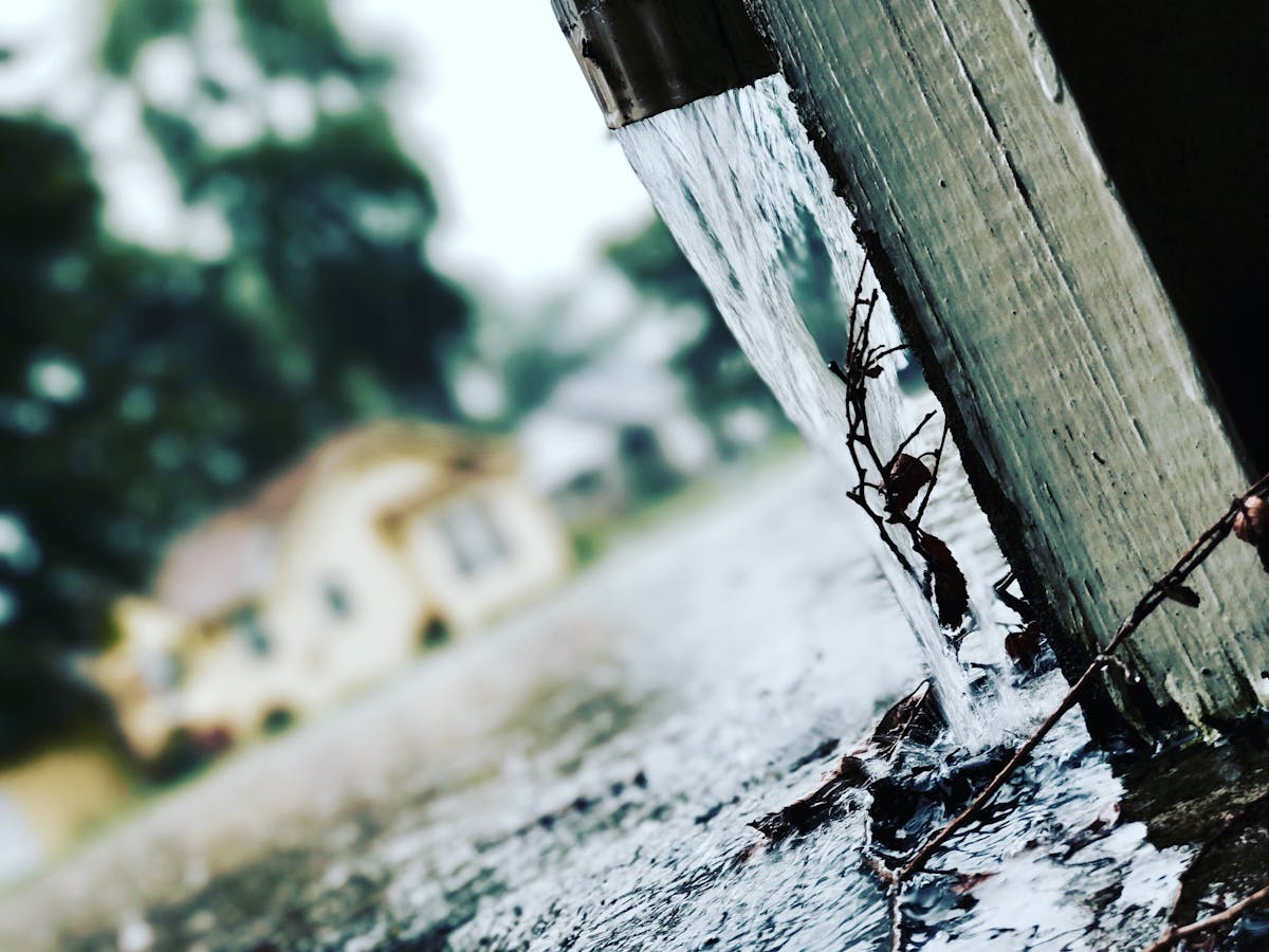 Rainwater flowing from a gutter during a storm