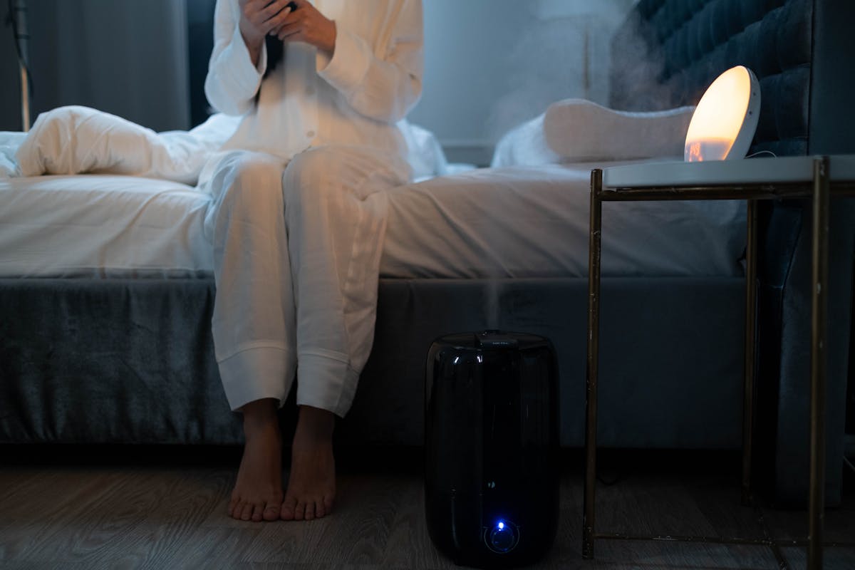 Bedroom humidifier mist in soft lighting